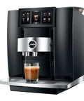 Top Shelf Fully Automatic Commercial Coffee Station Featuring Six Point Seven Inch Touchscreen Interface with a glass of espresso below.