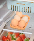 Organic Bamboo Deviled Egg Platter Featuring Six Secure Grid Wells For Fridge Storage And Kitchen Countertop Use with five eggs.