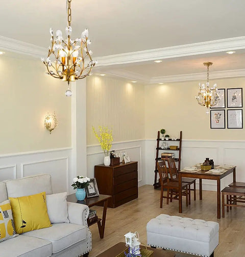 Living room with Three Light K9 Crystal Pendant Chandelier in Gold above a dining table, modern glam ceiling light.