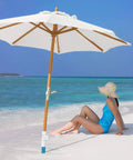 Windproof Beach Umbrella Sand Anchor With Five Spiral Screw Design Heavy Duty ABS Base Stand on beach with woman sitting nearby.