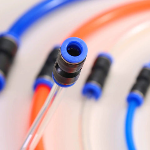 Close-up of blue push-to-connect pneumatic fitting on clear tubing (front view)