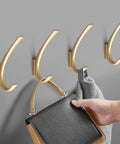 Knockout Vintage Black Zinc Alloy Wall Mount Hooks Slick Scratch Resistant Towel Ring And Coat Hanger For Bath Or Entryway heavy-duty hooks holding a handbag and towel.