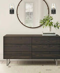 Room with dope matte black industrial wall sconces with clear glass shades near a mirror and wooden dresser