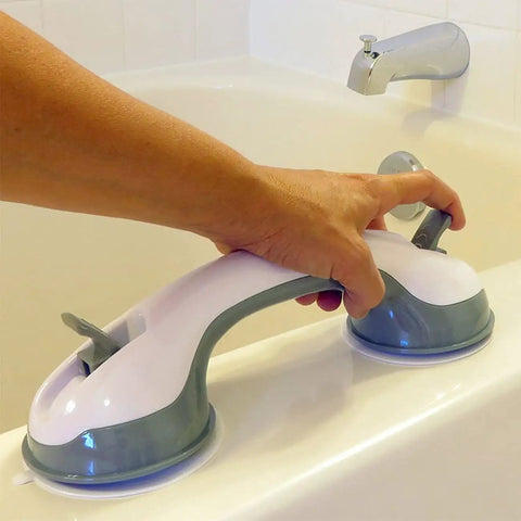 Suction grip handle attached to a bathtub edge, showing easy grip and secure mounting for bathroom safety.