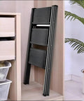 Smooth Operator Electric Attic Ladder With Remote Control And Heavy Duty Handrail adjustable folded in storage next to drawers.