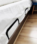 Ditch The Daily Slide, Keep Your Mattress Locked Down With These Heavy Duty Retainer Bars, Black Metal Slide Stopper Brackets For Platform And RV Beds, Easy Install Anti Slip Rails That Hold Fast, close view of brackets under bed.