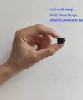 Hand holding Thirty Pcs Black Plastic Hole Plugs For Cabinet And Screw Holes, 13 Mm Bottom Diameter, 17 Mm Cap Diameter