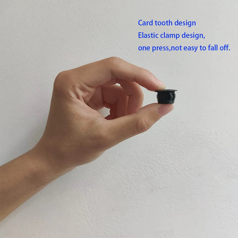 Hand holding Thirty Pcs Black Plastic Hole Plugs For Cabinet And Screw Holes, 13 Mm Bottom Diameter, 17 Mm Cap Diameter