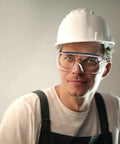 Man wearing ANSI certified Kick Up Dust Without Fogging Out These Safety Glasses Fit Seamless Over Your Specs Scratch Proof Lenses.