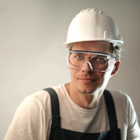 Man wearing ANSI certified Kick Up Dust Without Fogging Out These Safety Glasses Fit Seamless Over Your Specs Scratch Proof Lenses.