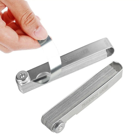 High Precision Guitar Feeler Gauge Set, 32 Stainless Steel, 0.0008 To 0.040 Inch Thickness Range, hand holding gauge strip