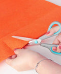 Four Piece Scissors Set With Premium Stainless Steel Blades And Ergonomic Semi Soft Rubber Grip cutting orange fabric