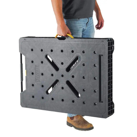 Person carrying folded Express Folding Workbench With Quick Setup In Under 3 Seconds Beefy 1000 Lbs Metal Legs Large Work Surface