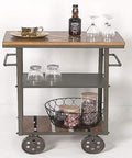 Heavy Duty Metal Industrial Rolling Cart With Three Roomy Shelves For Kitchen Storage Bar Setup and Home Organization Top Shelf Iron Frame Wood Finish Smooth Glide Utility Trolley with drinks and glassware on top shelf.