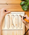 Hands using 6 In 1 Charcuterie Board Handle Template Clear Acrylic Routing Jig for crafting wood handles.