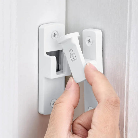 White 90 Degree Barn Door Lock With Right Angle Slide Latch For Sliding Wood Panels in use on a wooden door.