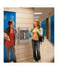 Two students chatting near a Heavy Duty Battery Powered Mechanical Bottle Filling Station With Filtered Stainless Surface Mount.