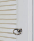 Side view of vintage bronze ring cabinet pull handle with screws on white louvered door for kitchen dresser cupboard furniture hardware retro metal ring knob for classic cabinets and timeless decor upgrade home improvement old school charm.