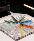 Colored Borosilicate Glass Blowing Tubes 8 Piece Set Heavy Duty High Temp Resistant for Industrial Lab and Craft Projects on silver cloth.