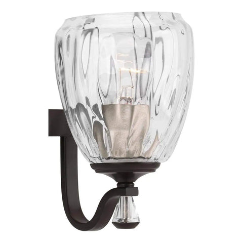 Close-up of Anjoux Collection 3-Light Clear Water Glass Luxe Bath Vanity Light in Antique Bronze, showing glass texture.