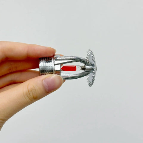 Five Pack Heavy Duty Chrome Brass Fire Sprinklers Automatic Thermal Trigger Built Like A Tank For Home And Business Up To Sixty Eight Degrees Celsius Three Quarter Inch Upright Design, hand holding one sprinkler head.