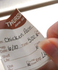 Close-up of Thursday label being applied, part of 1 Inch Day Of The Week Removable Labels Set With Dispenser Box Monday Through Sunday