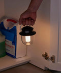 Person using Rechargeable 800 Lumen LED Lantern With Carabiner Handle And USB C Charging Ports for emergency light in cabinet