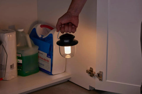 Person using Rechargeable 800 Lumen LED Lantern With Carabiner Handle And USB C Charging Ports for emergency light in cabinet