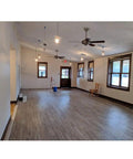 Empty room with hardwood floors and ceiling fans, potential installation site for G3 Flex 1080p Indoor Outdoor Security Cam With Night Vision And HDR.
