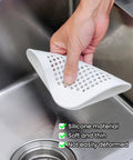 Heavy Duty Two Pack Square Hair Drain Catcher And Tub Filter With Grip Tight Suction Pads To Keep Your Shower Bathtub And Kitchen Sink Totally Clear Grey held above a kitchen sink.
