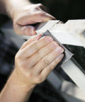 18 Piece Wet And Dry Sandpaper Set Pro Grade 3000 5000 7000 Grit being used on wood