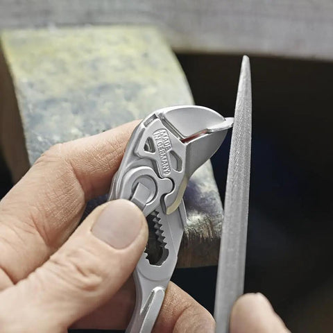 Close-up of All-In-One Adjustable Pliers Wrench Set For Inch And Metric Nuts And Bolts With Smooth Non-Marring Jaws in use