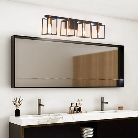 Farmhouse Style Four Light Vanity Fixture With Black And Antique Brass Metal Cage For Bathroom Vintage Rustic Wall Sconces Mid Century Look 33.85 Inch Long installed above a large mirror in modern bathroom