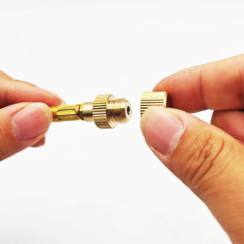 Hands holding Go To Compact Brass Gas Canister Cap With Knurled Rubber Seal And End Protector Durable Sealing Stopper 14x14x10mm
