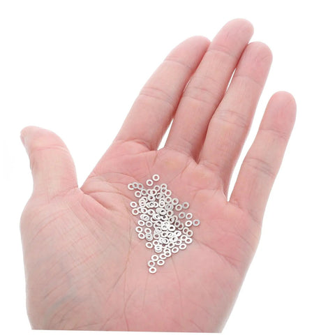Close-up of a hand holding 200 pcs eyewear rimless glasses washers cushions gaskets for quick repairs, versatile eyeglass frame accessories.
