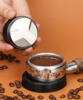 Hand holding 53mm Adjustable Coffee Distributor And Espresso Leveler For 54mm Breville Portafilters Pro Grade Gear