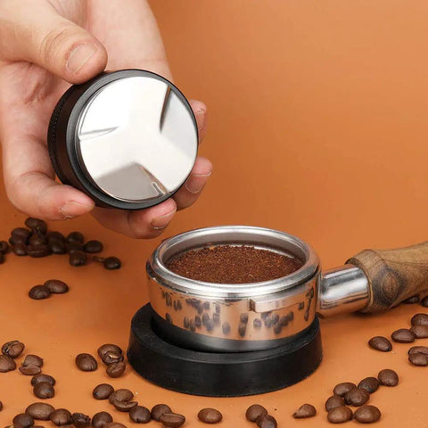 Hand holding 53mm Adjustable Coffee Distributor And Espresso Leveler For 54mm Breville Portafilters Pro Grade Gear