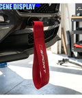 Custom Red Deco Tow Strap For Car Bumper And Trunk, Stylish Trailer Belt Plus Towing Rope Auto Exterior Bling With Abs Hook, Personalized Racing Stripe Decor That Gives Your Whip Serious Street Cred mounted on car bumper.