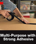 3M Multi-Use Duct Tape, black, 1.88 in x 20 yd roll, being applied to a cardboard box