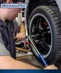 Mechanic using 2-In-1 Lug Wrench And Torque Wrench, 1/2 Inch Drive With Sockets on car wheel in workshop