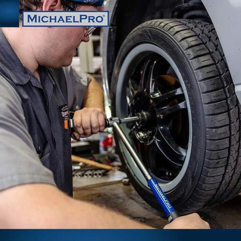 Mechanic using 2-In-1 Lug Wrench And Torque Wrench, 1/2 Inch Drive With Sockets on car wheel in workshop