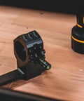 One Piece Bolt Action Scope Mount With Thirty Mil Medium Rings For Remington Seven Hundred Short Action showing level adjustment on a wooden surface.