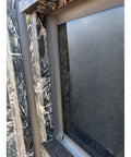 Close-up view of a window frame on the Kick Ass Solid 6X8 Wooden Deer Blind Featuring Hella Warm R6 Insulation Panels.