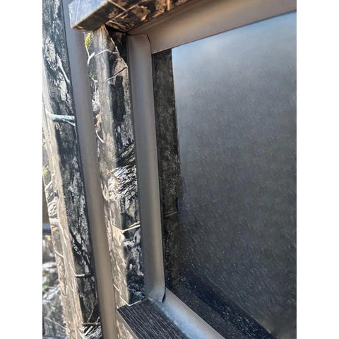 Close-up view of a window frame on the Kick Ass Solid 6X8 Wooden Deer Blind Featuring Hella Warm R6 Insulation Panels.