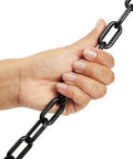 Close-up of hand holding Heavy Duty Black Plastic Chain Links 100 Ft for Safety Barriers on fences and gates, weather resistant.