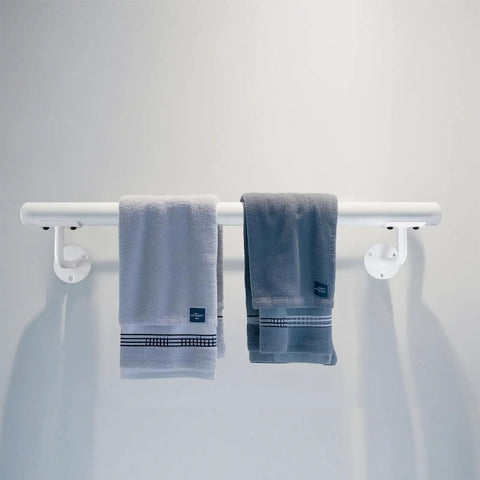 Built Like A Tank Two Foot White Steel Stair Railing With Heavy Duty Wall Mount Brackets To Keep Your Footing Locked Down On Indoor And Outdoor Steps As A Senior Grab Bar with two gray towels hanging.