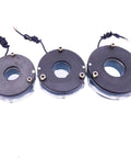 Three black electromagnetic power-off brake assemblies with central bore and mounting screws.