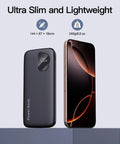 Two Pack Heavy Duty 10000mAh Portable Charger Power Bank Featuring Integrated Lightning And Usb C Cables Fast Charge Four Smartphones Simultaneously next to a smartphone, showcasing slim design and digital display.
