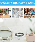 Romisbaba Electric Rotating Jewelry Display Stand For Bracelets Watches With Motorized Turntable And Cool LED Lighting in a boutique setting.