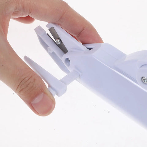 Hand holding safety lock feature of cordless electric scissors for fabric cutting handheld sewing tool.